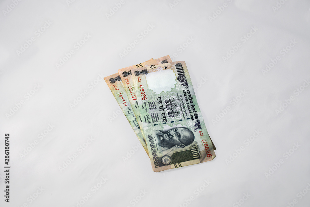 Wrinkled & used old Indian One Hundred Rupees Currency Notes on a minimal grey background Wrinkled & used old Indian One Hundred Rupees Currency Notes on a minimal grey background