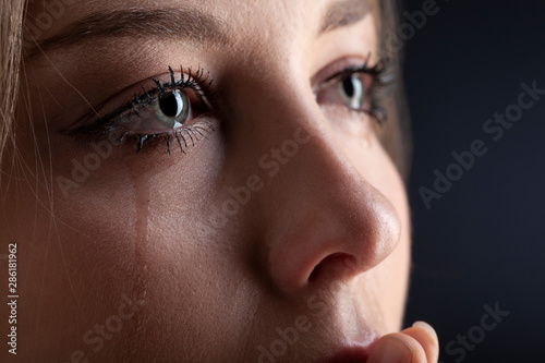 Papier peint tears on woman face, beauty girl cry on black background
