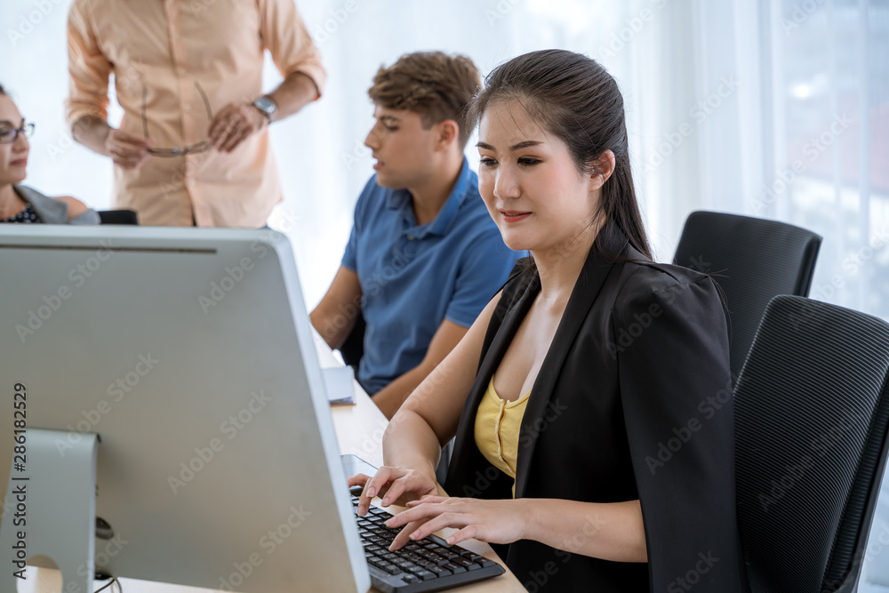A beautiful young businessman is using a computer to work within the office. A beautiful young businessman is using a computer to work within the office.