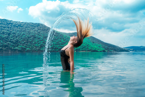 Beautiful girl splashing in...