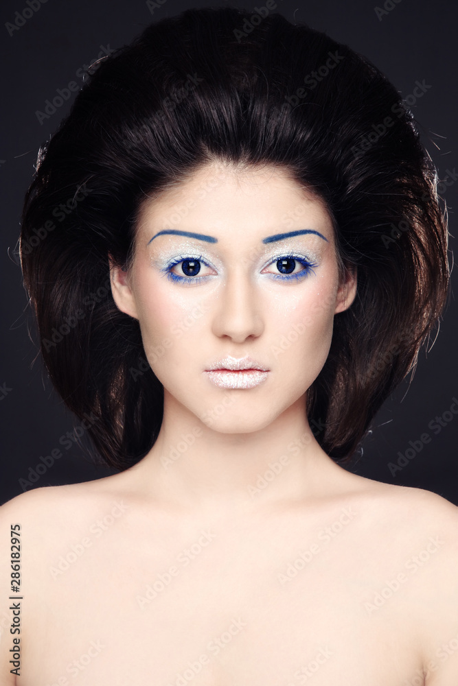 Portrait of young beautiful woman with fancy makeup and hairdo Portrait of young beautiful woman with fancy makeup and hairdo