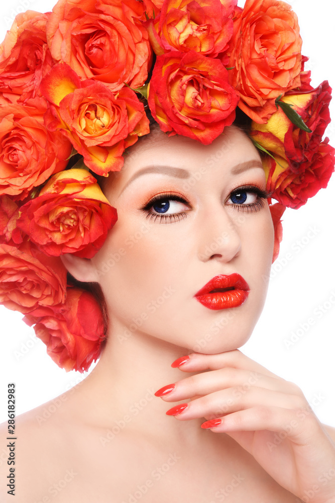 Vintage style portrait of young beautiful woman with fancy makeup and wig of orange roses