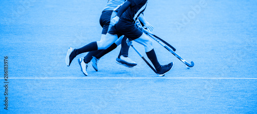 Photography Two man battle for control of ball during field hockey game