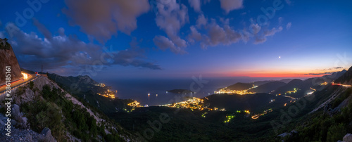 Budva riviera night coastline. Montenegro, Balkans, Adriatic sea. View from the top of the mountain road path.