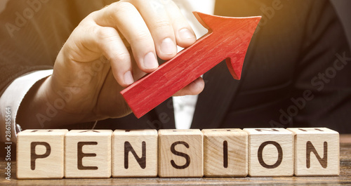 Wooden blocks with the word Pension and up arrow. Improving the financial condition of older people. Surcharge and pension supplements. Loan portfolio growth. Increase pensions fund. Growing payments