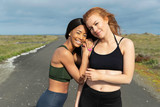 Two women in athletic clothes outside together