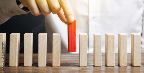 Businessman holds a wooden block in his hands. The concept of personnel selection and management within the team. Dismissal and hiring people to work. Human Resource Management. Leader selection