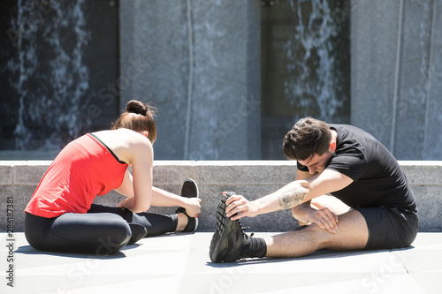 Healthy couple stretching in yoga exercise