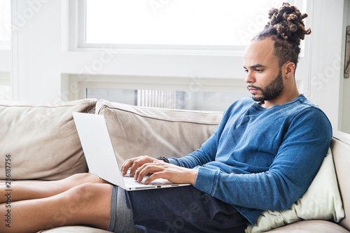 Valokuva Handsome African American man with dreadlocks at home