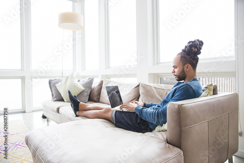 Valokuva Handsome African American man with dreadlocks at home
