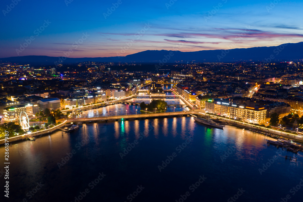 Aerial night view of Geneva city waterfront skyline in Switzerland Aerial night view of Geneva city waterfront skyline in Switzerland