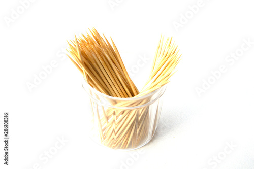 Toothpicks isolated on white background. Tooth picks spilling out of container.