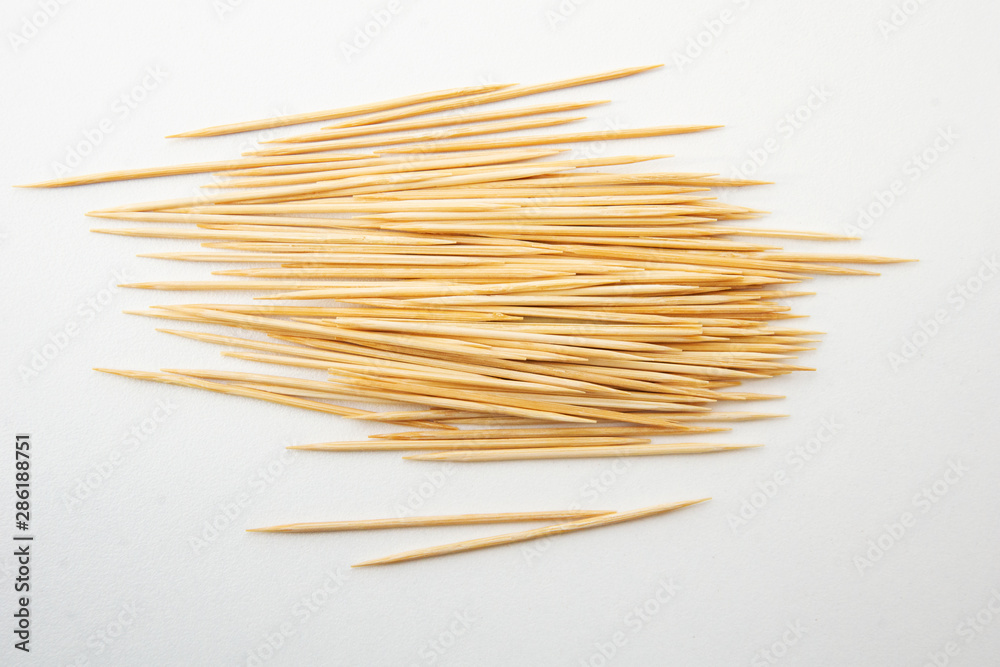Toothpicks isolated on white background. Tooth picks spilling out of container.