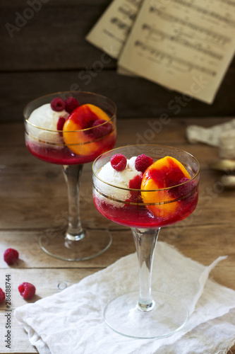 Obraz na płótnie Ice cream, peach and raspberry sauce dessert dedicated to Australian opera singer Melba. Rustic style. w salonie