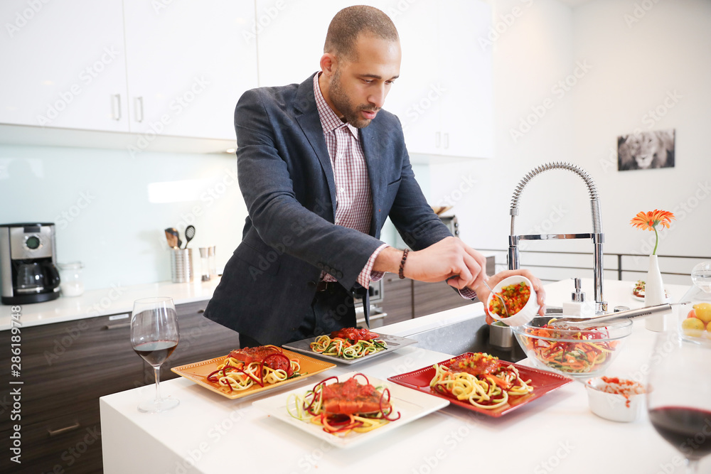 Young couple cooking at home together Young couple cooking at home together