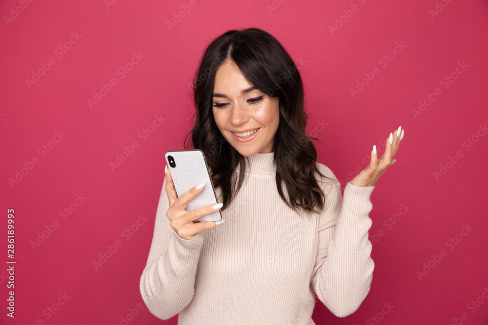 Portrait of pretty happy person using phone isolated on the pink background Portrait of pretty happy person using phone isolated on the pink background