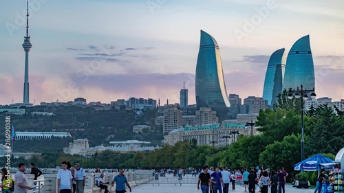 Unidentified people walking with background of panoramic cityscape view of Baku, Hyperlapse video, capital city of Azerbaijan on sunset light