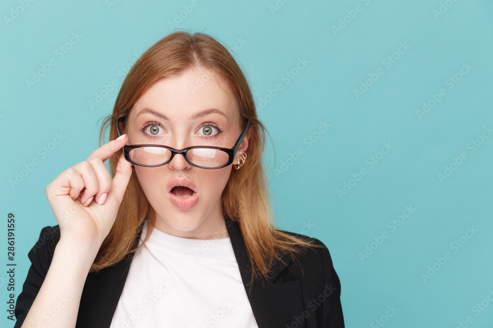 Amazed woman getting glasses up isolated Amazed woman getting glasses up isolated