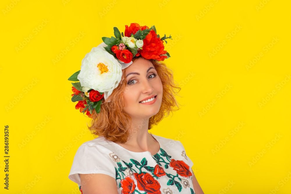 Happy young woman in a wreath of flowers Happy young woman in a wreath of flowers