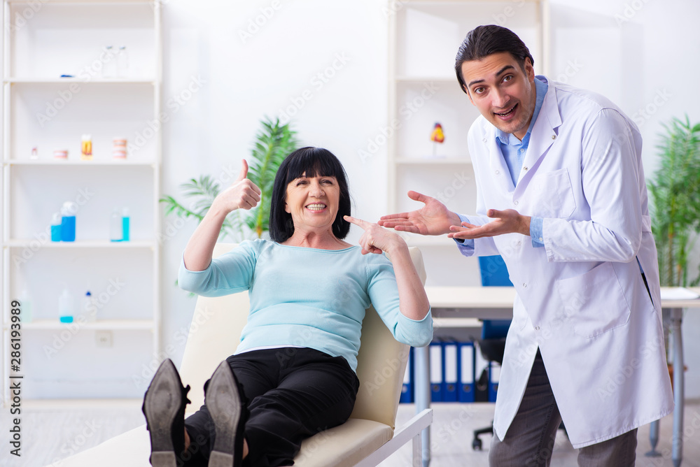 Fototapeta premium Old woman visiting young doctor dentist