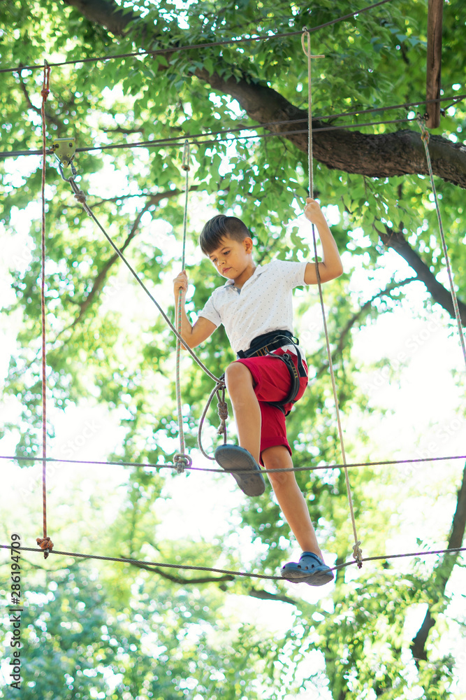 young boy, teenager, in a rope park, engage in extreme games, child development, boy hobbies