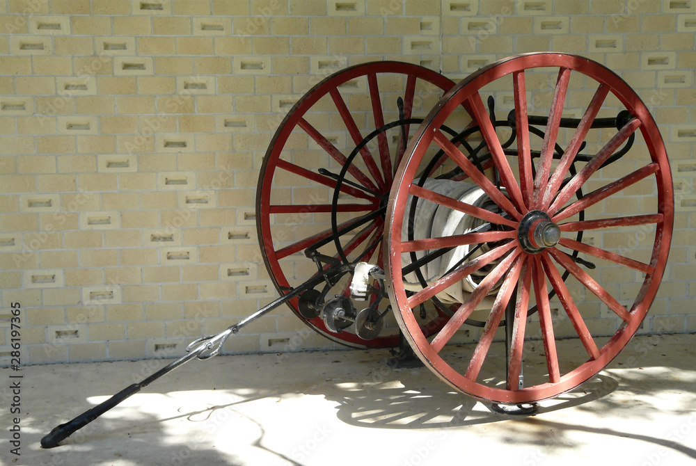 Foto Stock Antique Fire Hose Cart Firefighting Wagon. This antique fire