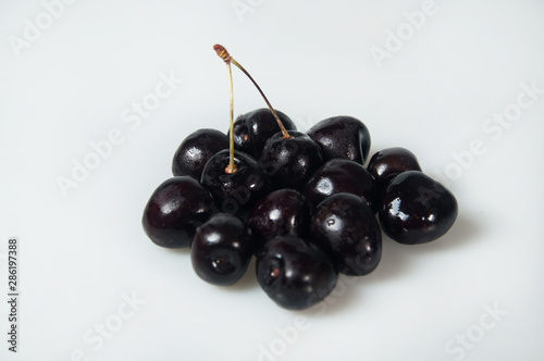 Composition on white background with cherry