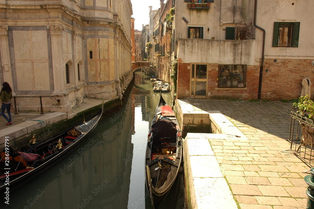 Venice canal with boats and vintage walls