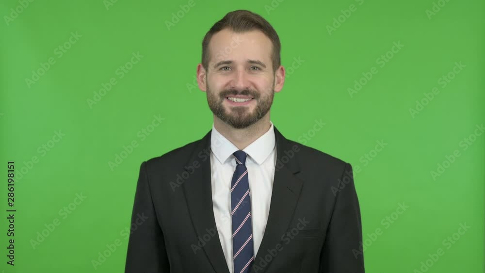 Cheerful Businessman Smiling at Camera against Chroma Key Cheerful Businessman Smiling at Camera against Chroma Key