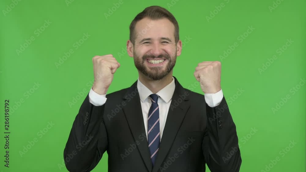 Happy Businessman getting Surprise and showing Fists against Chroma Key Happy Businessman getting Surprise and showing Fists against Chroma Key
