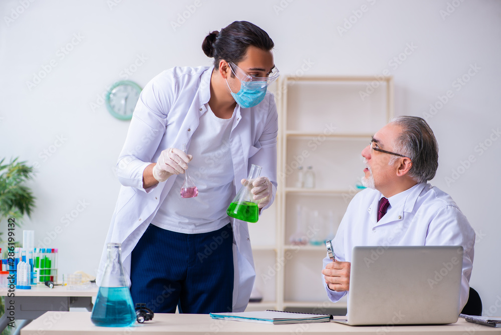 Two chemists working in the lab Two chemists working in the lab