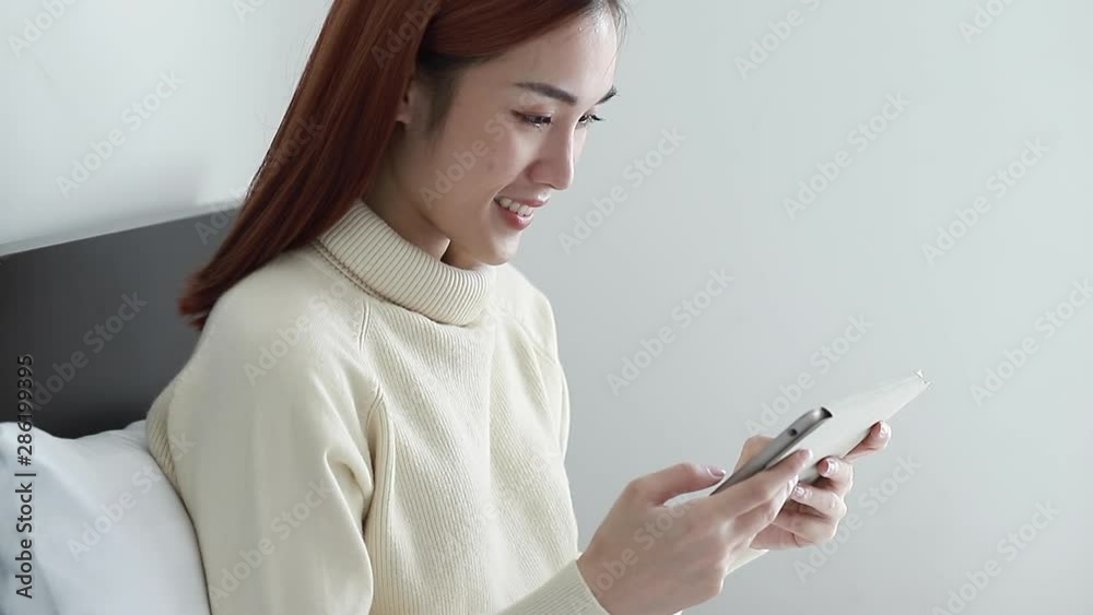 Close up Asian woman wearing yellow long-sleeved shirts play game or application on phone Close up Asian woman wearing yellow long-sleeved shirts play game or application on phone