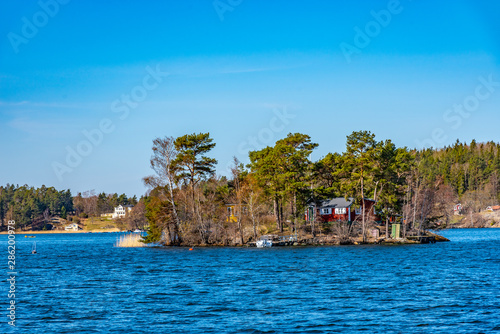 Forrested island on lake malaren near Stockholm, Sweden photo