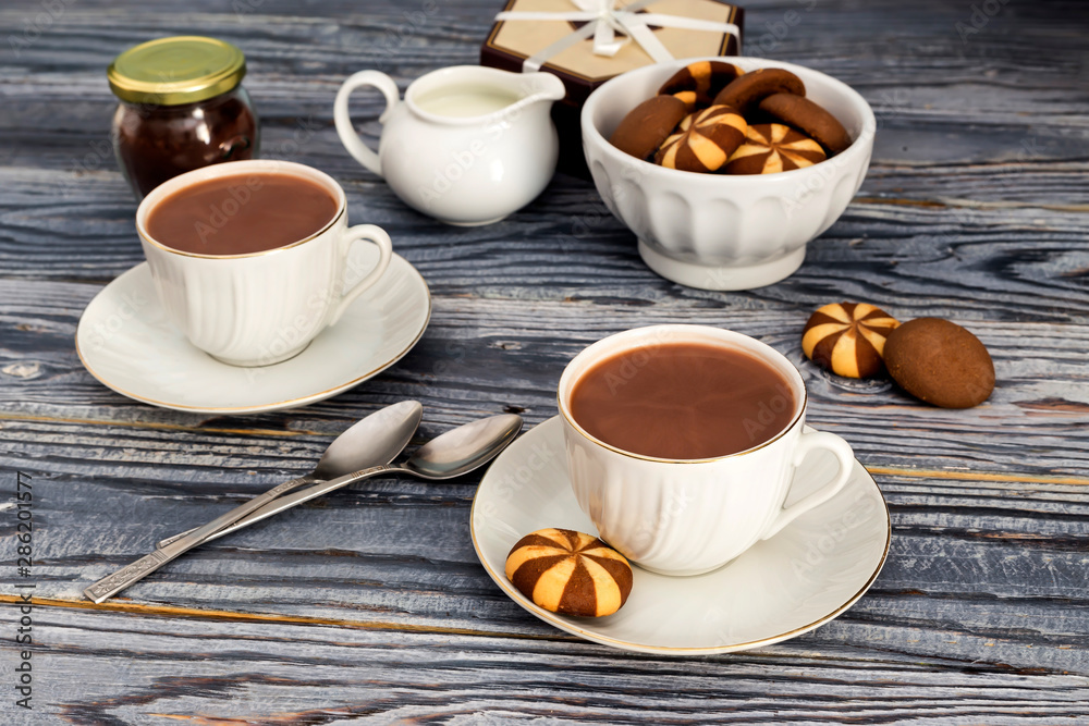 Cups with cocoa on a wooden table Cups with cocoa on a wooden table