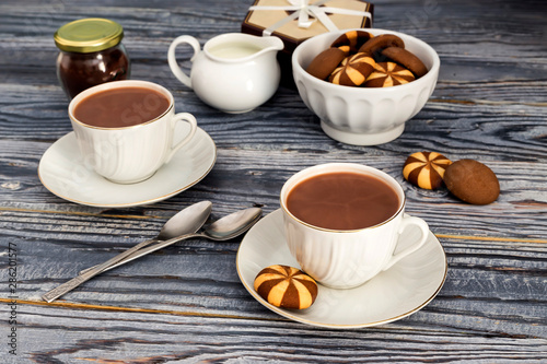 Cups with cocoa on a wooden table