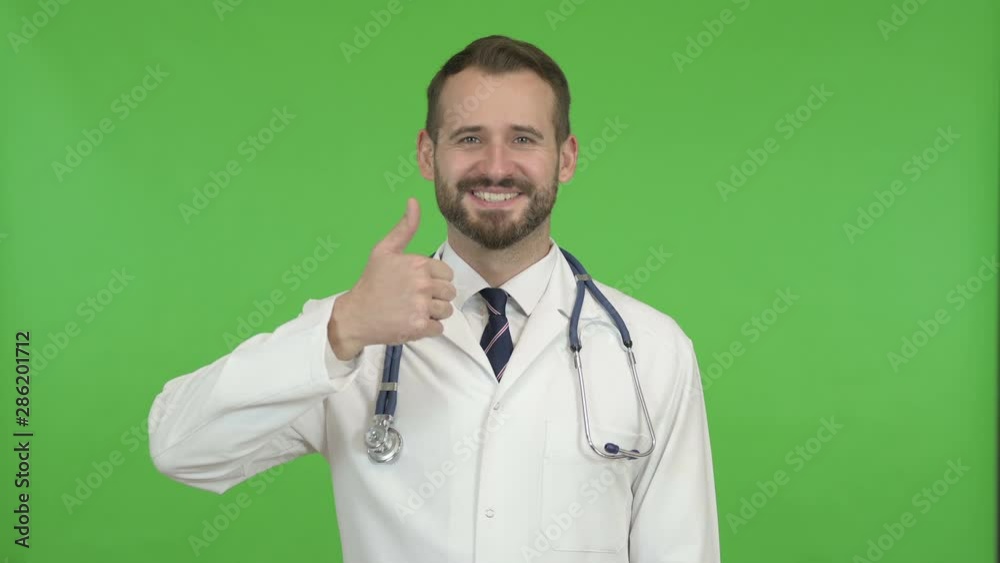 Cheerful Doctor Showing Thumbs Up against Chroma Key Cheerful Doctor Showing Thumbs Up against Chroma Key