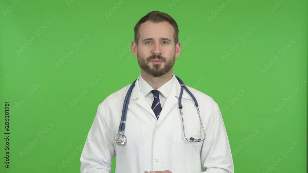 Handsome Doctor Waving and Talking against Chroma Key Handsome Doctor Waving and Talking against Chroma Key