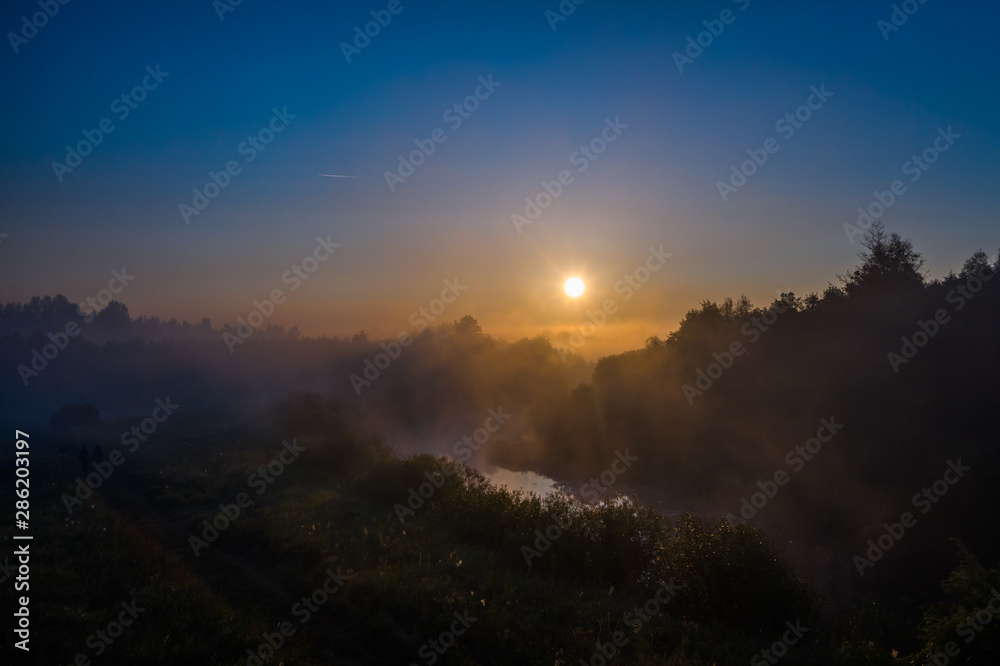 Fototapeta premium golden morning fog over the river