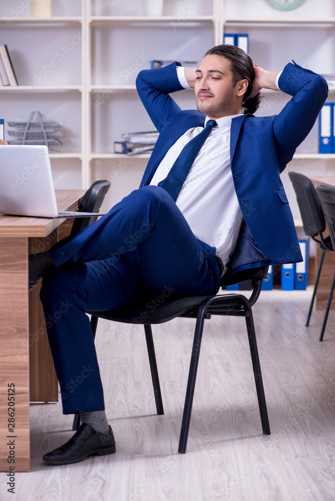 Young handsome businessman working in the office Young handsome businessman working in the office