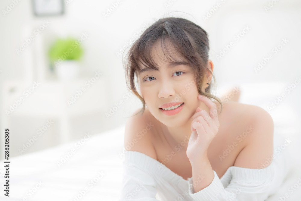 Beautiful portrait young asian woman lying and smile while wake up with sunrise at morning, beauty cute girl happy and cheerful resting on bed in the bedroom, lifestyle and relax concept. Beautiful portrait young asian woman lying and smile while wake up with sunrise at morning, beauty cute girl happy and cheerful resting on bed in the bedroom, lifestyle and relax concept.