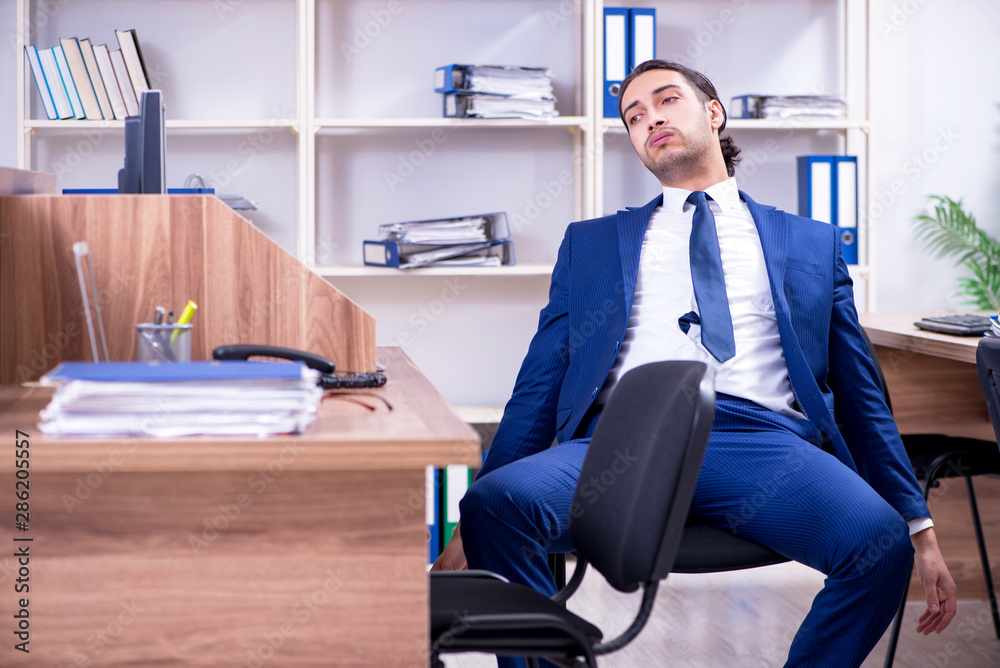 Young handsome businessman working in the office Young handsome businessman working in the office