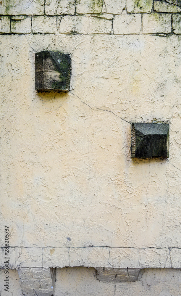 Texture of light yellow paint stucco on brick wall. Imitation of old castle wall Texture of light yellow paint stucco on brick wall. Imitation of old castle wall