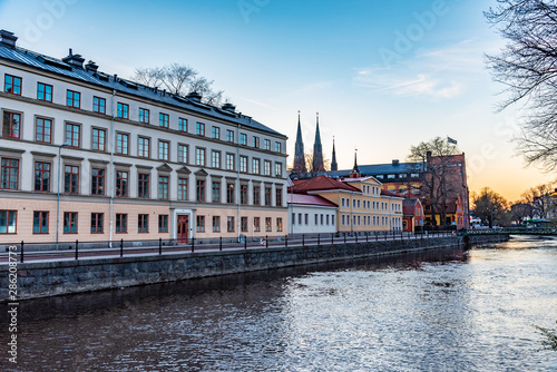 Sunset view of notable buildings alongside river Fyris in Uppsala, Sweden photo