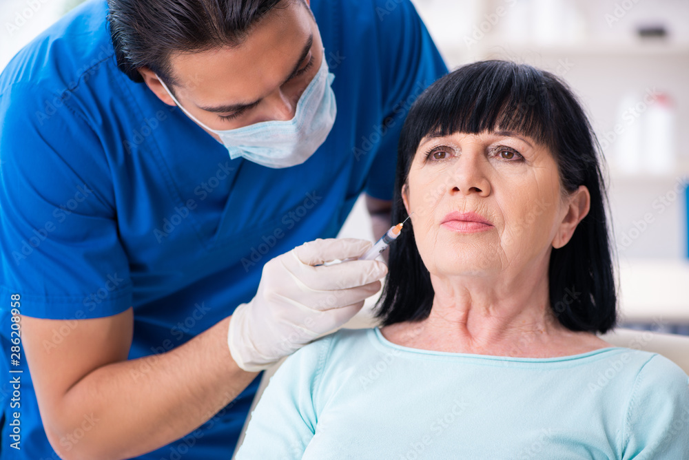 Old woman visiting male doctor for plastic surgery Old woman visiting male doctor for plastic surgery