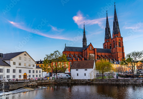 Sunset view of white building of Uppland museum and cathedral in Uppsala, Sweden photo