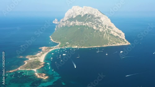 View from above, stunning aerial view of the beautiful Tavolara Island with its beach bathed by a turquoise clear sea. Tavolara is a small island off the northeast coast of Sardinia, Italy. photo