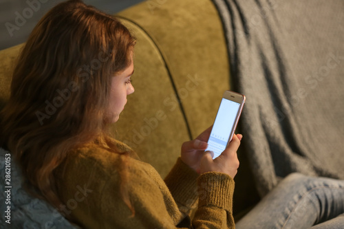 Teenage girl with mobile ph...