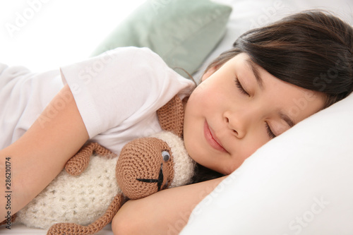 Little girl sleeping in bed...