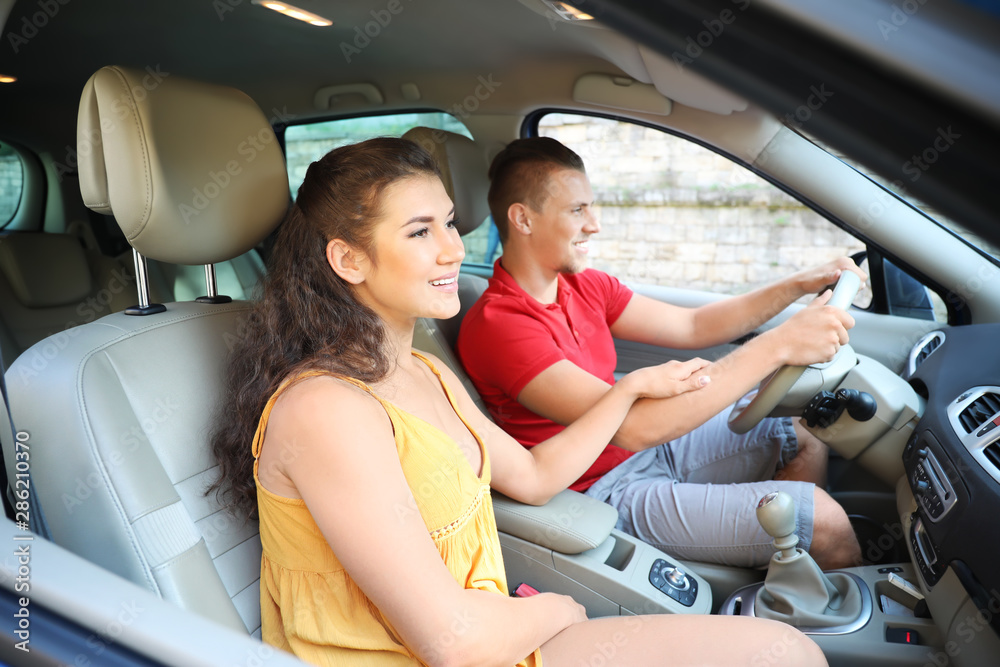 Happy young couple traveling by car Happy young couple traveling by car