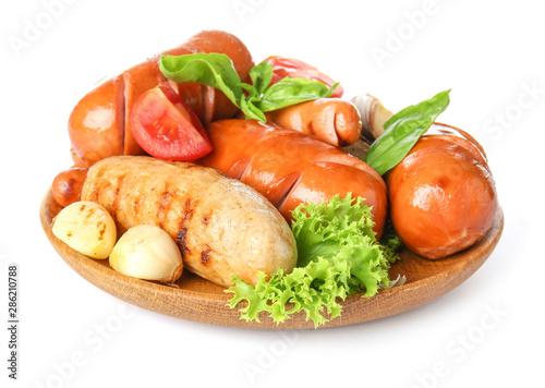 Plate with tasty grilled sausages on white background